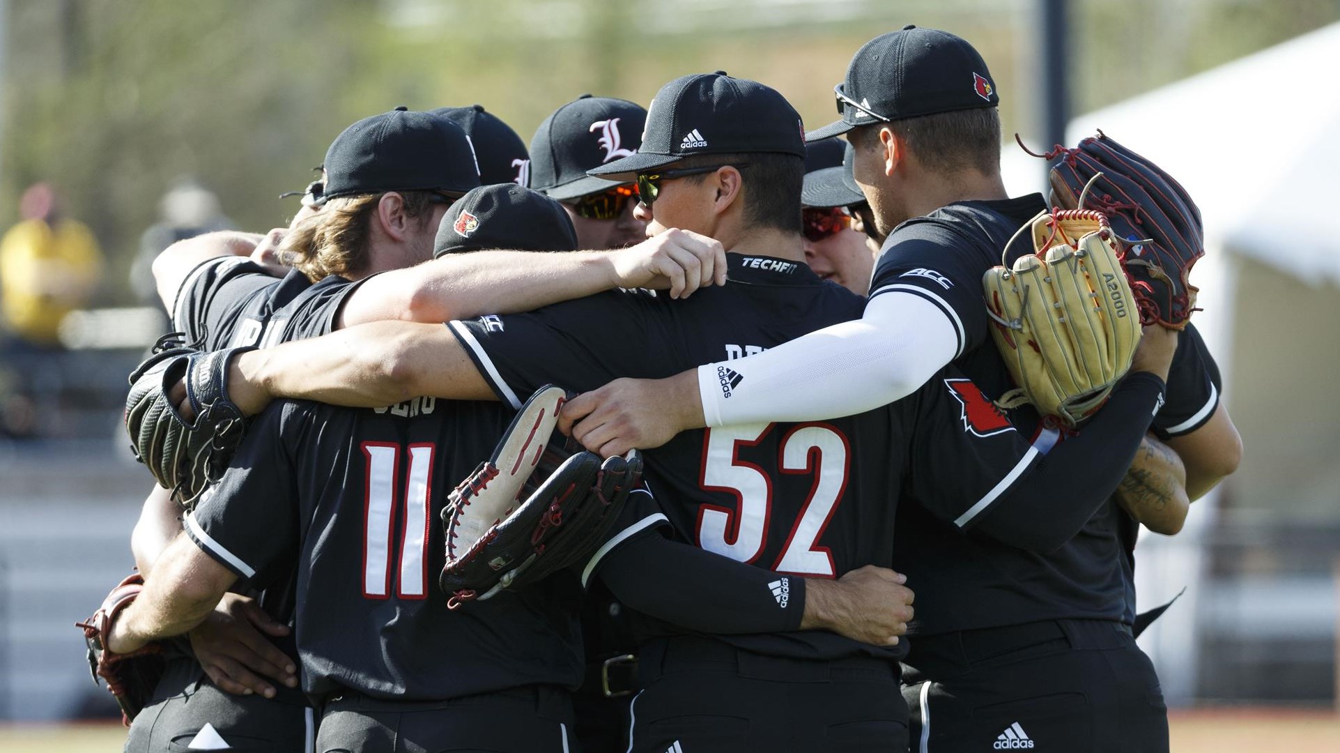 The Cardinals huddle before the game against Florida State at Jim Patterson Stadium on April 9.